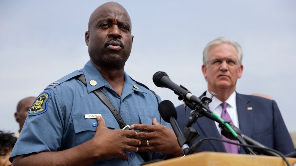 Capt. Ron Johnson of the Missouri Highway Patrol, left, answers questions as Gov. Jay Nixon listens during a news conference Friday, Aug. 15, 2014, in Ferguson, Mo.