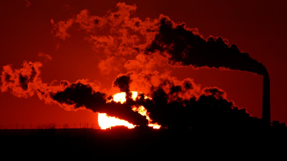 In this March 8, 2014 file photo steam a coal-fired power plant is silhouetted against the setting sun near St. Marys, Kan.