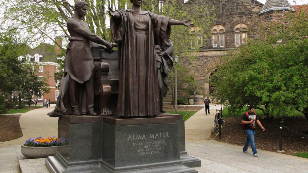 Students walk past the Alma Mater statue, a landmark on the University of Illinois campus in Urbana, Ill., April 28, 2015. (Photo by David Mercer/AP)