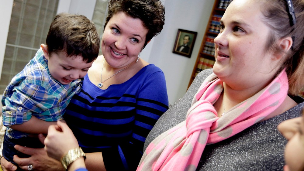 Nicole Yorksmith, left, holds her son while standing with her partner Pam Yorksmith, on Feb. 10, 2014, following a news conference in Cincinnati.