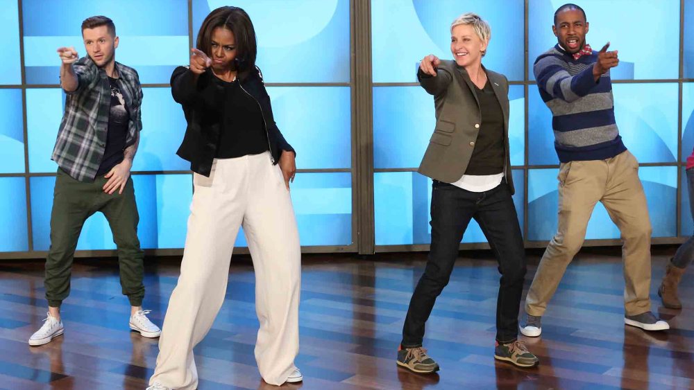 n this photo released by Warner Bros., talk show host Ellen DeGeneres, second right, dances with first lady Michelle Obama's as she takes part in Obama's #GimmeFive Challenge. (Photo by Mike Rozman/Warner Bros./AP)
