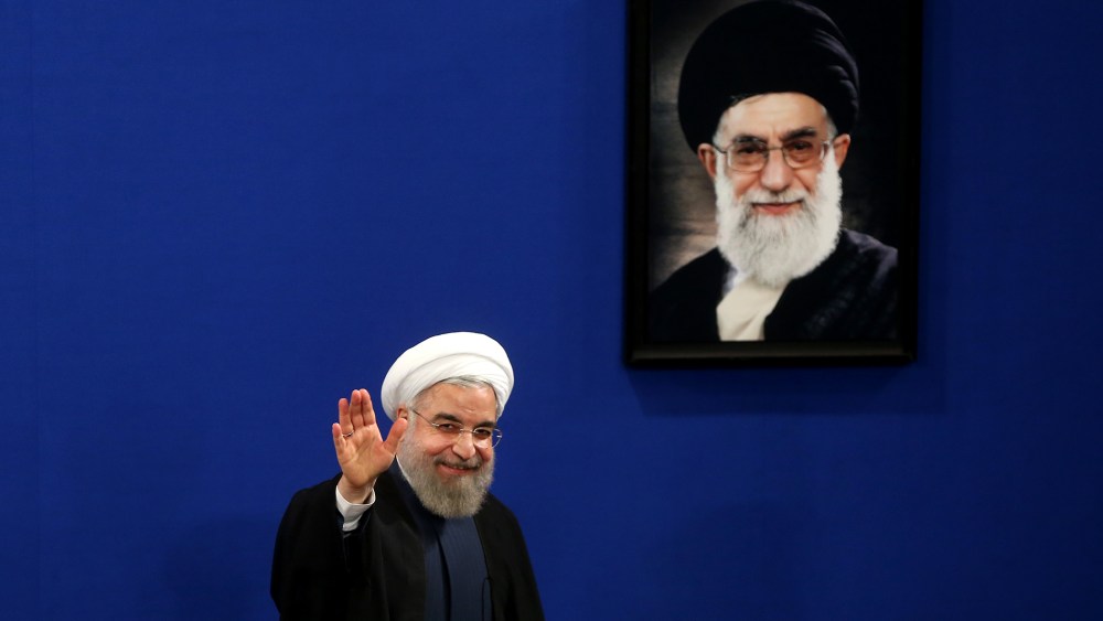 Iran's President Hassan Rouhani waves to reporters at the conclusion of his press conference in Tehran, Iran, Aug. 29, 2015. (Photo by Ebrahim Noroozi/AP)