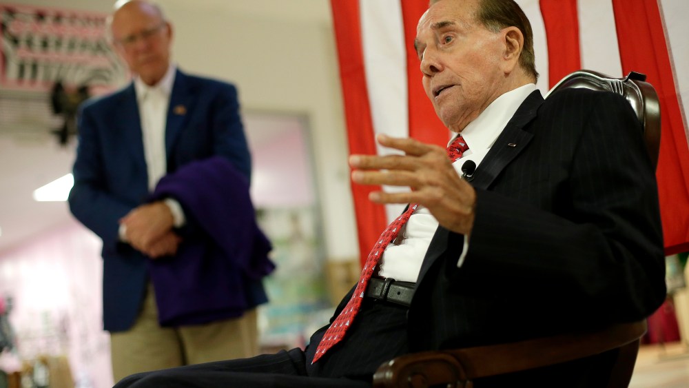 Republican Sen. Pat Roberts listens while former Senate Majority Leader Bob Dole, right, speaks during a campaign stop at a mall in Dodge City, Kan, Monday, Sept. 22, 2014.