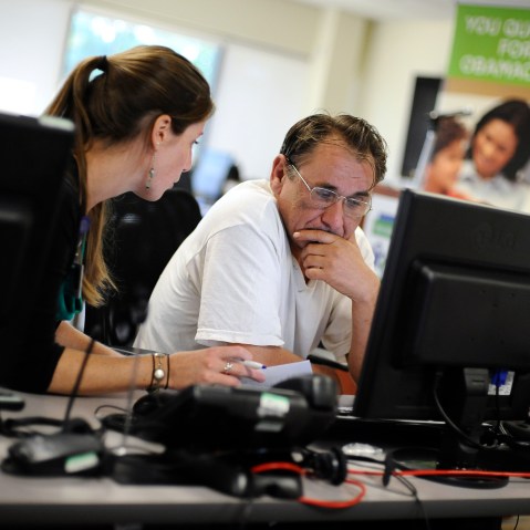 Outreach and eligibility associate Shannon Bali helps Boguslaw Dudek enroll in the nation's new health insurance system at the Community Health Center, in New Britain, Conn., Oct. 1, 2013.
