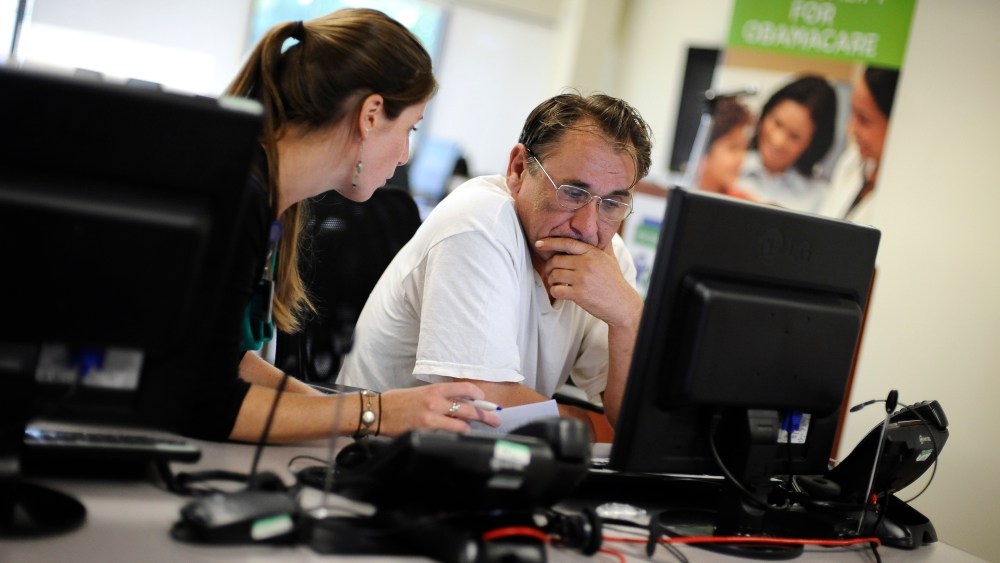 Outreach and eligibility associate Shannon Bali helps Boguslaw Dudek enroll in the nation's new health insurance system at the Community Health Center, in New Britain, Conn., Oct. 1, 2013.