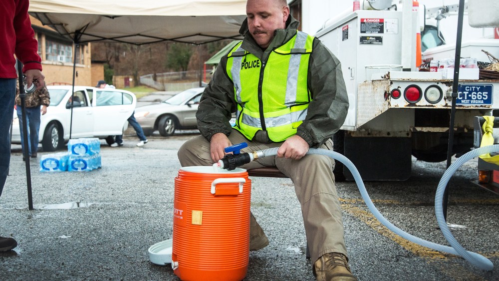 Chief of Police Brian Oxley helps distribute water to local residents, Jan. 11, 2014.