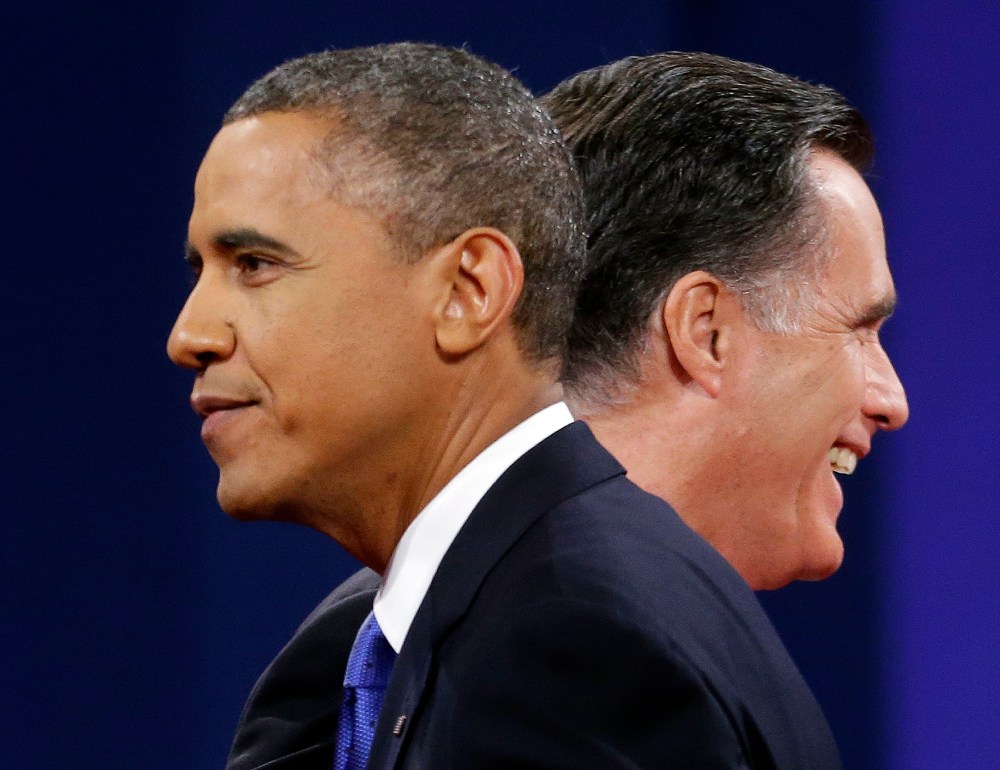Republican presidential candidate, former Massachusetts Gov. Mitt Romney and President Barack Obama walks past each other on stage at the end of the last debate at Lynn University, Monday, Oct. 22, 2012, in Boca Raton, Fla. (AP Photo/Pablo Martinez...
