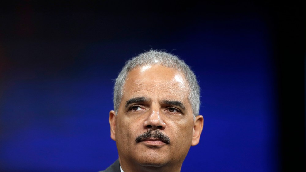 Attorney General Eric Holder listens to a speech ahead of his remarks during the Annual International Association of Chiefs of Police Conference on Oct. 21, 2013