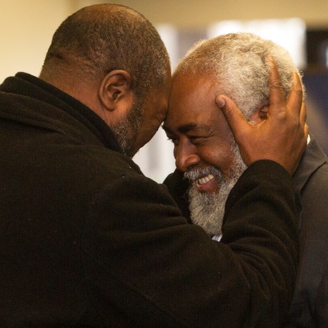 Wiley Bridgeman 60, right, of Cleveland, is greeted by his brother Ronnie, who is now known as Kwame Ajamu, after his release from a life sentence an hour earlier, by Cuyahoga County Common Pleas Judge David Matia, Nov. 21, 2014, in Cleveland.