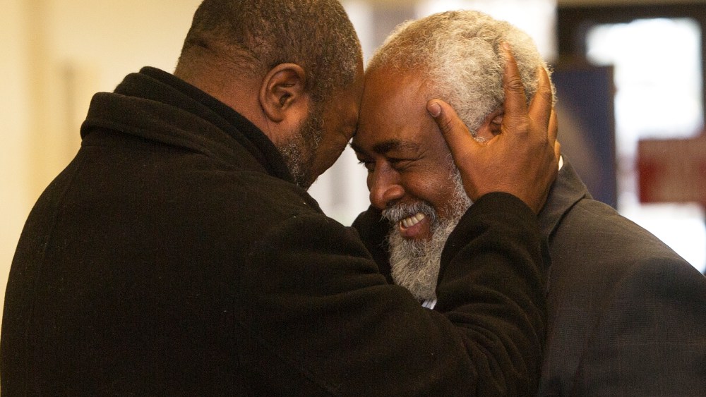 Wiley Bridgeman 60, right, of Cleveland, is greeted by his brother Ronnie, who is now known as Kwame Ajamu, after his release from a life sentence an hour earlier, by Cuyahoga County Common Pleas Judge David Matia, Nov. 21, 2014, in Cleveland.