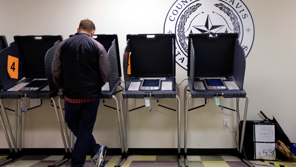 In this Wednesday, Feb. 26, 2014 photo, a voter casts his ballot at an early voting polling site, in Austin, Texas.
