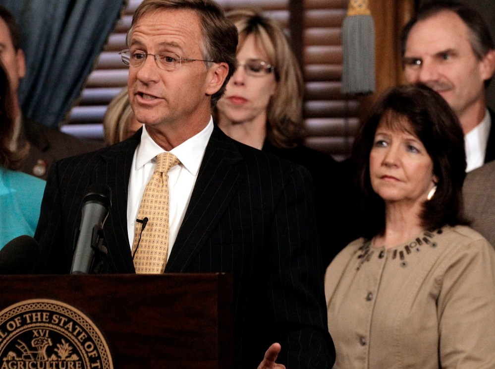 In this Jan. 10, 2012 file photo, Rep. Sheila Butt, lower right, listens as Gov. Bill Haslam talks in Nashville, Tenn. The Tennessee Legislative Black Caucus said Butt should apologize for a Facebook post they say is racist. (Photo by Mark Humphrey/AP)