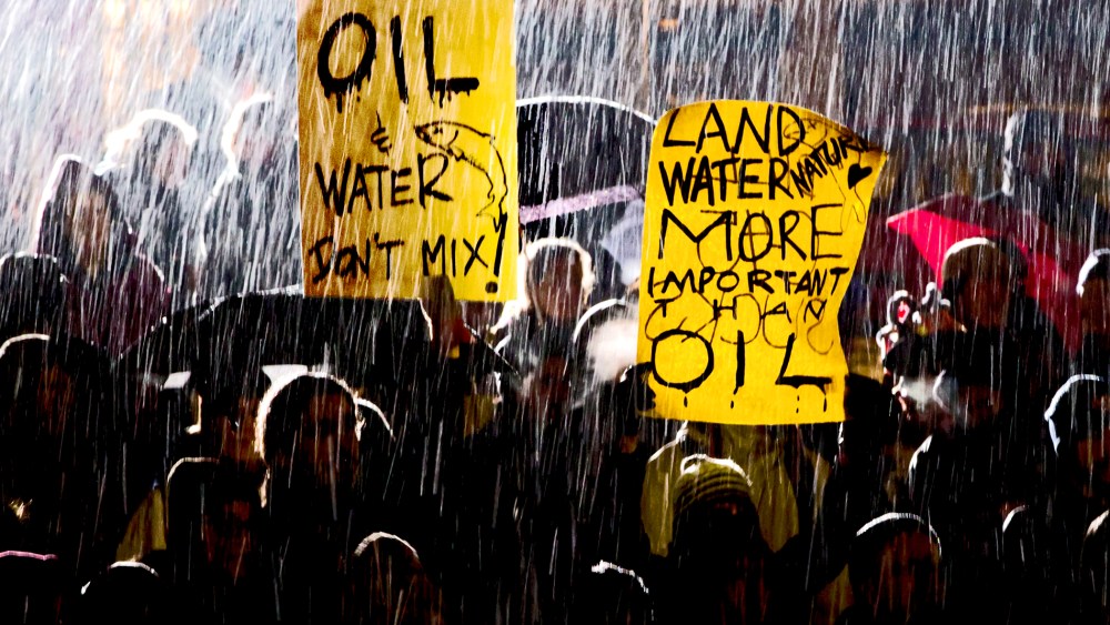 Wet snow falls as protesters demonstrate against the Enbridge Northern Gateway Pipeline in Vancouver, B.C., Jan. 14, 2013.