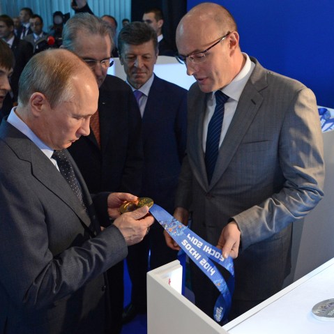Russia's President Vladimir Putin, second left, and IOC President Jacques Rogge, third left, look at the unveiled Sochi 2014 Olympic Medals displayed at an IOC executive board meeting at the SportAccord International Convention in St. Petersburg, on...
