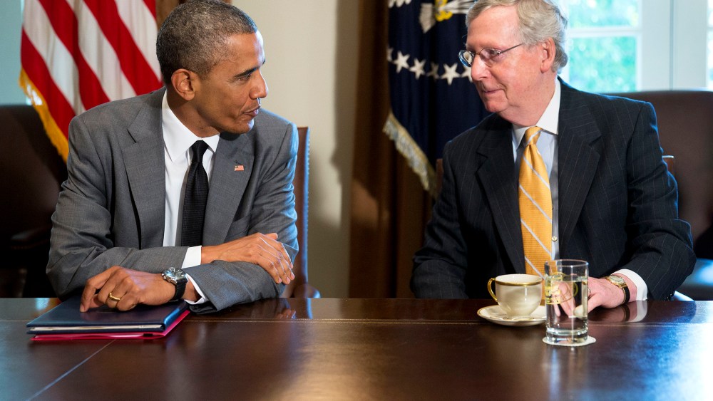 President Barack Obama talks to U.S. Senate Republican Leader Mitch McConnell (R-Ky.) during a meeting with members of Congress in Washington, D.C. on July 31, 2014. (Photo by Andrew Harrer/Picture-Alliance/DPA/AP)
