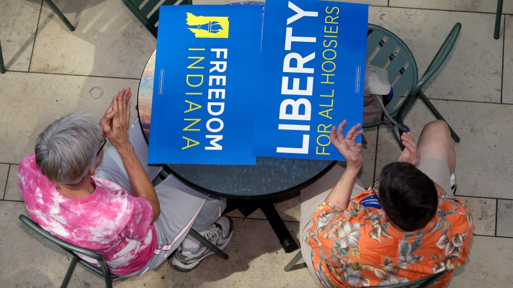 Same-sex marriage supporters listen during the announcement of the new group, called Freedom Indiana, in Indianapolis, Aug. 21, 2013.