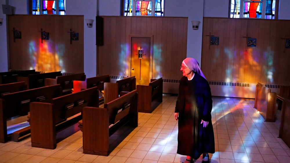 Mother Patricia Mary walks in the chapel at the Mullen Home for the Aged, run by Little Sisters of the Poor, Jan. 2, 2014, in Denver, Colo.