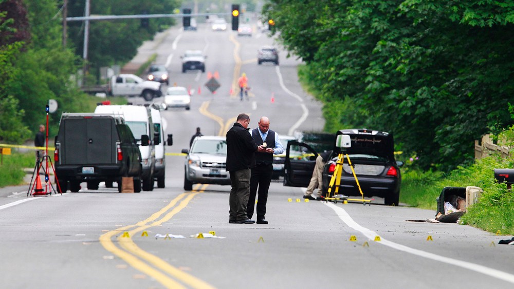 Investigators comb the scene of an officer-involved shooting on May 21, 2015 in Olympia, Wash. (Photo by Steve Bloom/The Olympian/AP)
