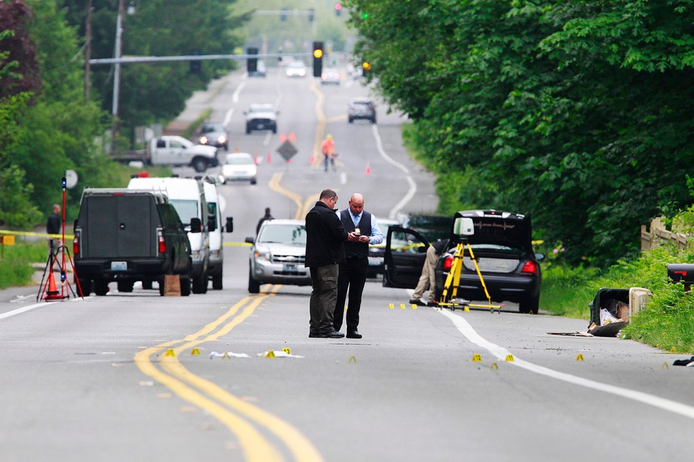 Investigators comb the scene of an officer-involved shooting on May 21, 2015 in Olympia, Wash. (Photo by Steve Bloom/The Olympian/AP)