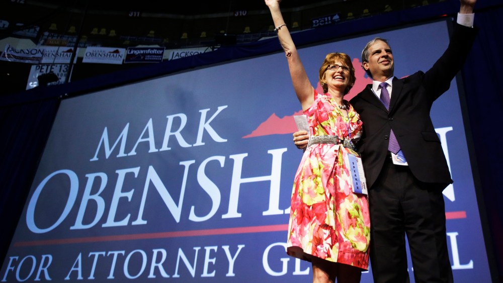 State Sen. Mark Obenshain waves to the crowd with his wife, Suzanne at the Virginia Republican convention, May 18, 2013.