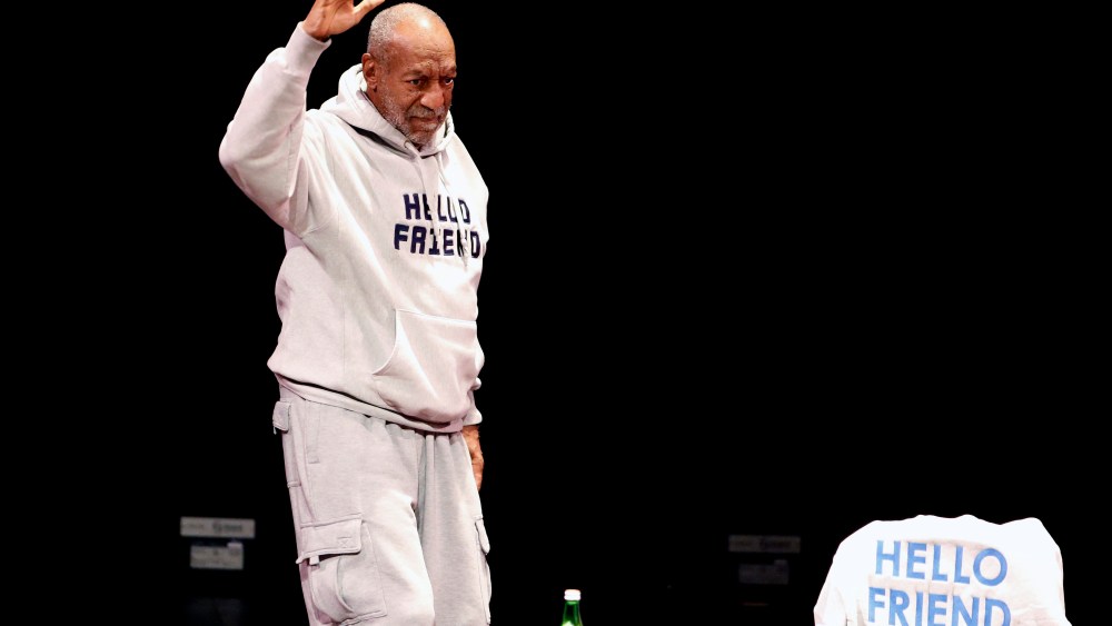 Comedian Bill Cosby waves as he walks onstage for a performance at the Buell Theater in Denver, Saturday, Jan. 17, 2015. (Photo by Brennan Linsley/AP)