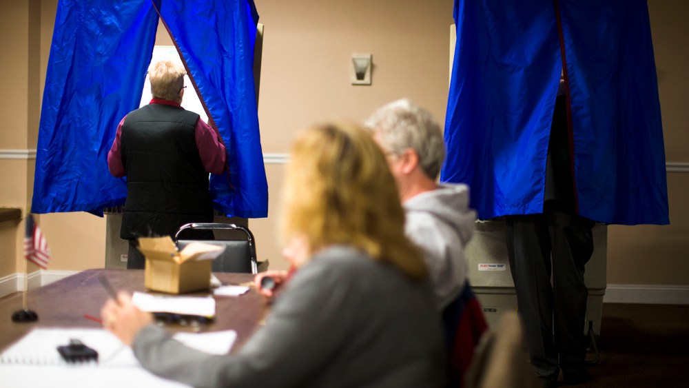 A voter steps into voting booth, Nov. 5, 2013, in Philadelphia, Pa.