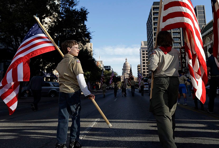 Boy Scouts carry U.S. flags up Congress Avenue towards the Texas Capitol during the annual Boy Scouts Parade and Report to State, Saturday, Feb. 2, 2013, in Austin, Texas. (Photo Eric Gay/AP)