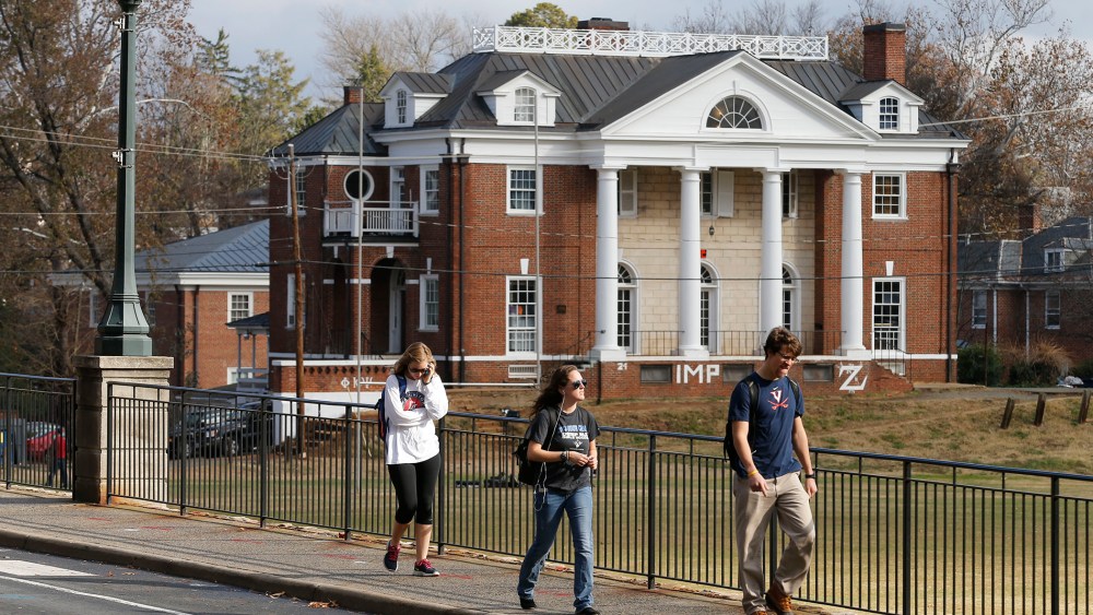 University of Virginia students walk to campus past the Phi Kappa Psi fraternity house at the University of Virginia in Charlottesville, Va. on Nov. 24, 2014. (Steve Helber/AP)