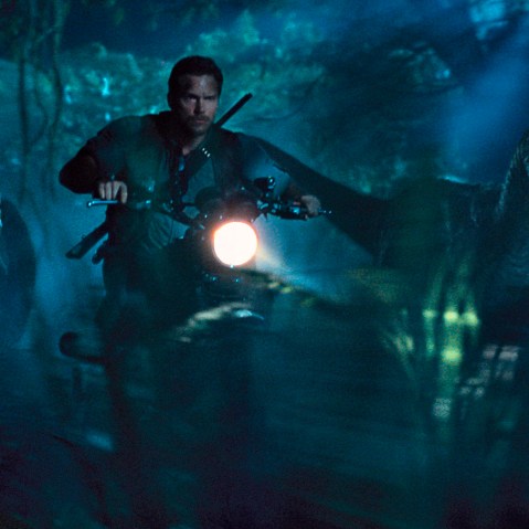 This photo provided by Universal Pictures shows, Chris Pratt as Owen leading the raptors on a mission in a scene from the film, "Jurassic World," directed by Colin Trevorrow. (Photo by ILM/Universal Pictures/Amblin Entertainment/AP)