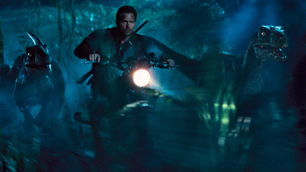 This photo provided by Universal Pictures shows, Chris Pratt as Owen leading the raptors on a mission in a scene from the film, "Jurassic World," directed by Colin Trevorrow. (Photo by ILM/Universal Pictures/Amblin Entertainment/AP)