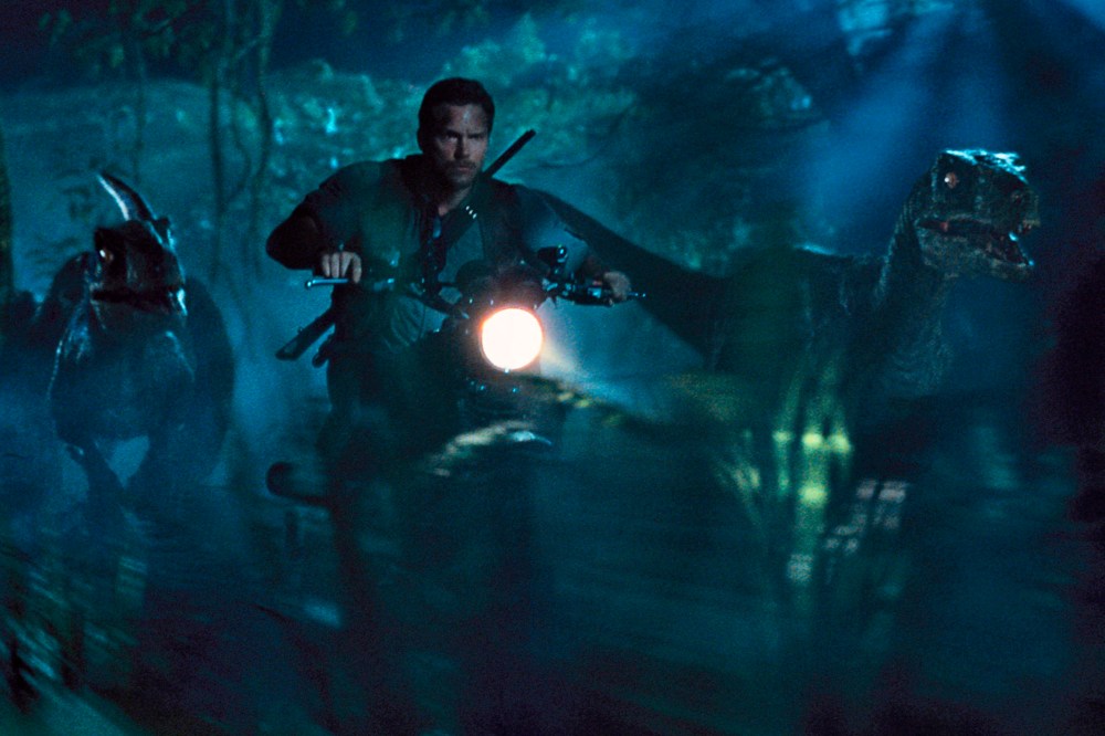 This photo provided by Universal Pictures shows, Chris Pratt as Owen leading the raptors on a mission in a scene from the film, "Jurassic World," directed by Colin Trevorrow. (Photo by ILM/Universal Pictures/Amblin Entertainment/AP)