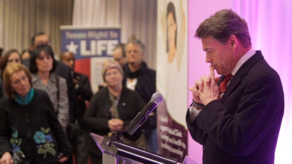 Governor Rick Perry pauses as he speaks during media conference at The Source for Women, Tuesday, Dec. 11, 2012, in Houston. (AP Photo/Houston Chronicle, Melissa Phillip)