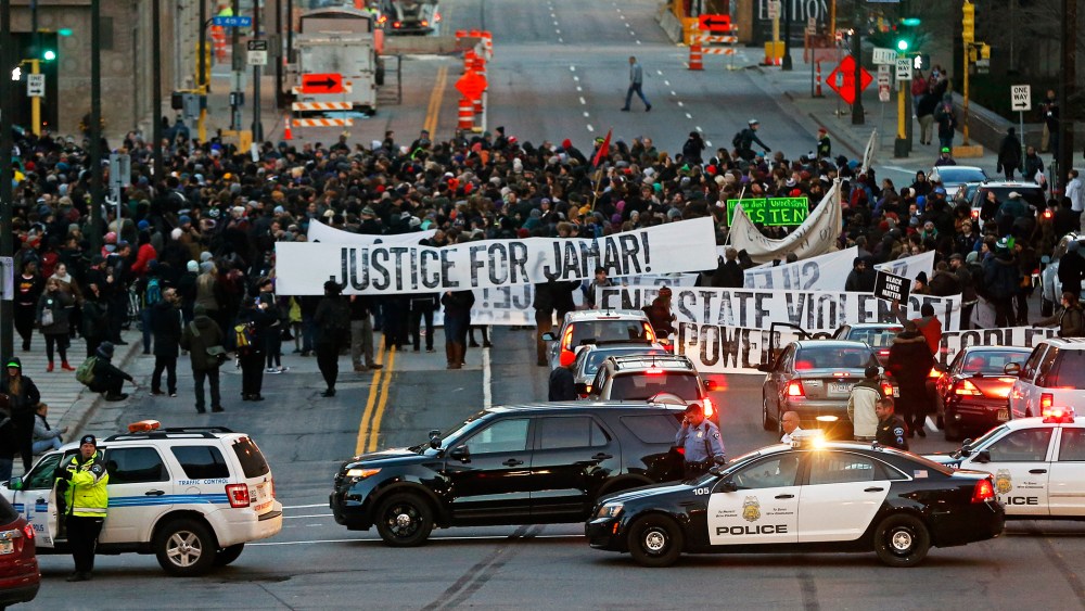 Hundreds of Black Lives Matter demonstrators and supporters occupy the street in front of the federal building, Nov. 24, 2015, in Minneapolis, after marching from the Police Department's Fourth Precinct. (Photo by Jim Mone/AP)