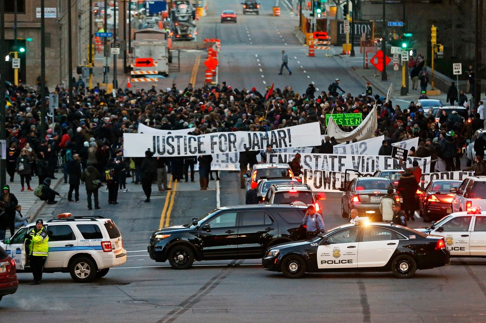 Hundreds of Black Lives Matter demonstrators and supporters occupy the street in front of the federal building, Nov. 24, 2015, in Minneapolis, after marching from the Police Department's Fourth Precinct. (Photo by Jim Mone/AP)