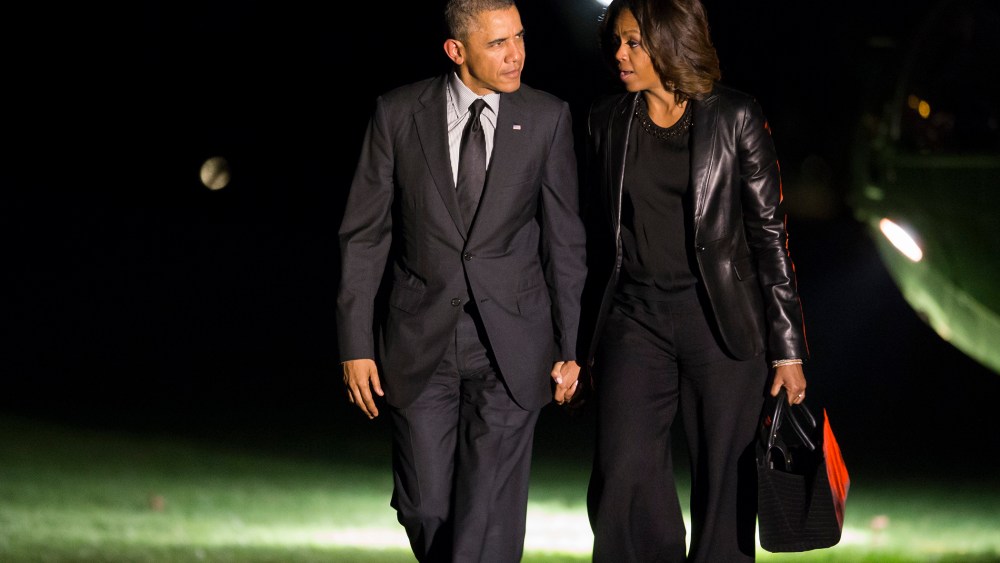President Barack Obama and first lady Michelle Obama walk to the White House after arriving on the South Lawn, April 12, 2014, in Washington, D.C.