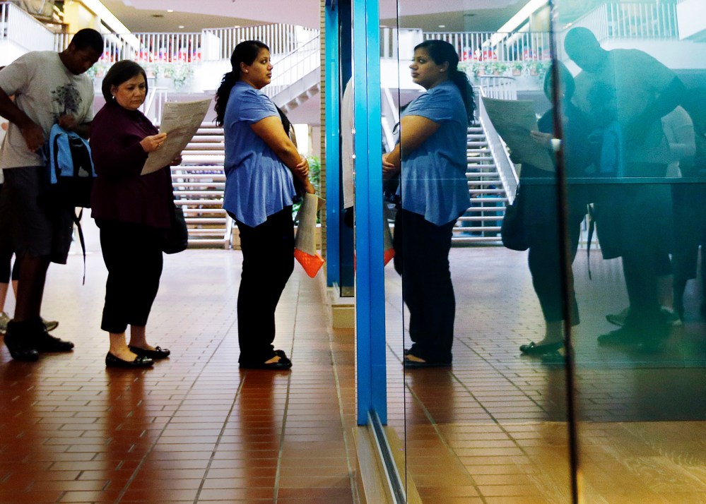 Voters wait in line at a polling place located inside a shopping mall, on Election Day, Tuesday, Nov. 6, 2012, in Austin, Texas