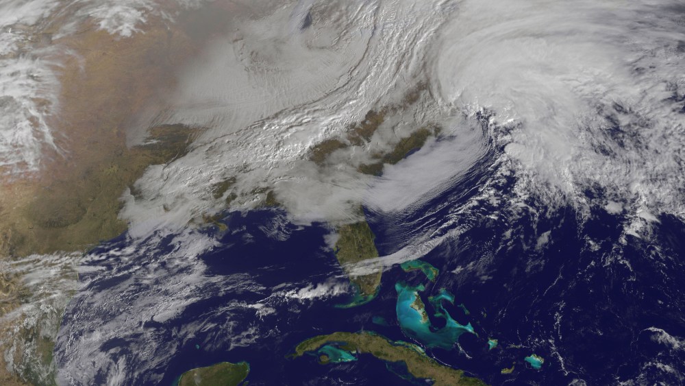 This image released by NASA from NOAA's GOES-13 satellite captured at 9:01 a.m. on Friday, Feb. 8, 2013 shows a massive winter storm coming together as two low pressure systems merge over the northeast U.S. Snow began falling across the Northeast on...