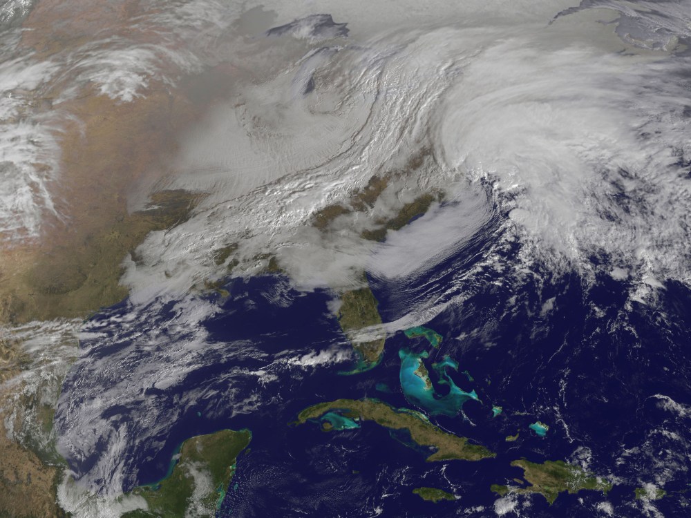 This image released by NASA from NOAA's GOES-13 satellite captured at 9:01 a.m. on Friday, Feb. 8, 2013 shows a massive winter storm coming together as two low pressure systems merge over the northeast U.S. Snow began falling across the Northeast on...