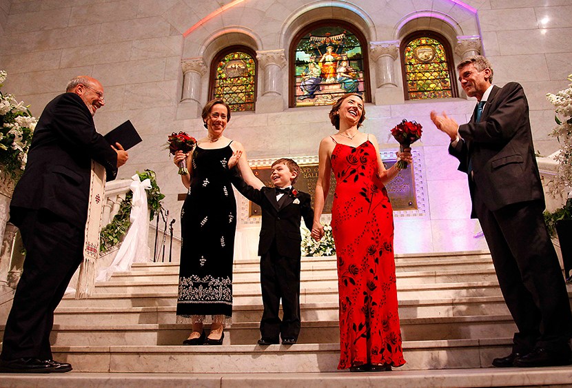 Cathy ten Broeke and Margaret Miles hold their son Louie's hand after walking the steps at Minneapolis City Hall to be married by Reverend James Gertmenian, left, and Mayor R.T. Rybak at the Minneapolis Freedom to Marry Celebration and Weddings,...