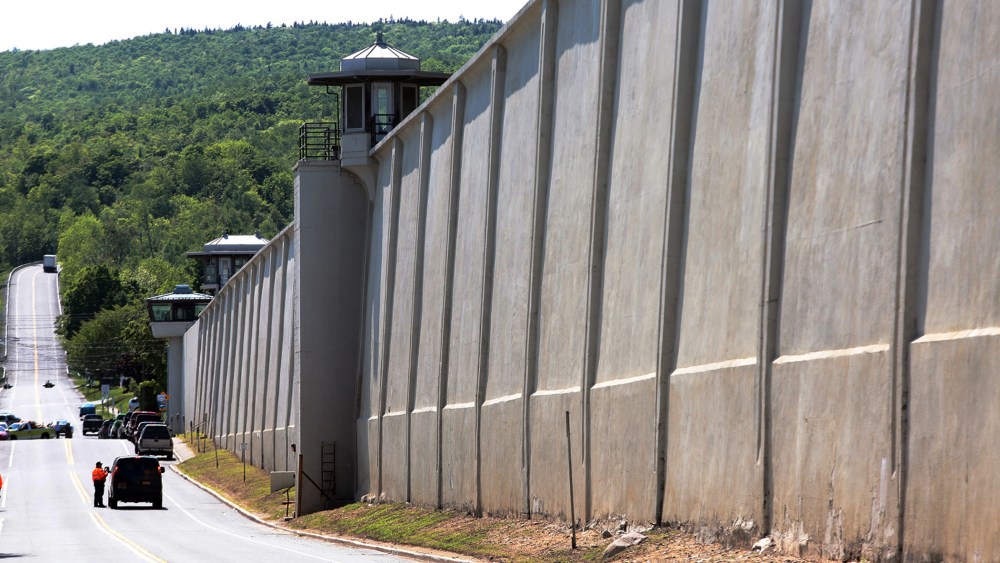 Law enforcement officers stand guard near one of the walls of the Clinton Correctional Facility in Dannemora, N.Y. on June 6, 2015. (Photo by Gabe Dickens/Press Republican/AP)