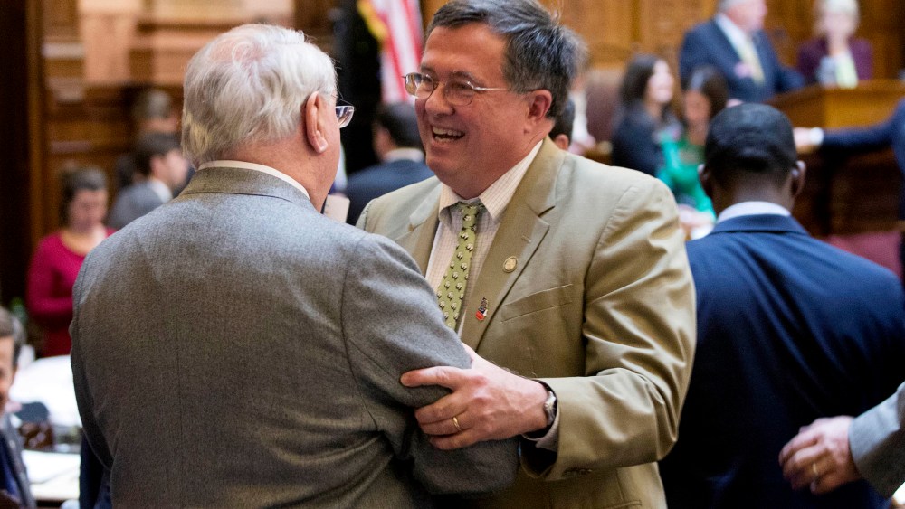 Georgia Rep. Rick Jasperse, R-Jasper, facing, celebrates with Rep. Wendell Willard, R-Sandy Springs, after a gun bill passed in the House Chambers on the last day of the legislative session at the Georgia State Capitol, on March 20, 2014, in Atlanta.