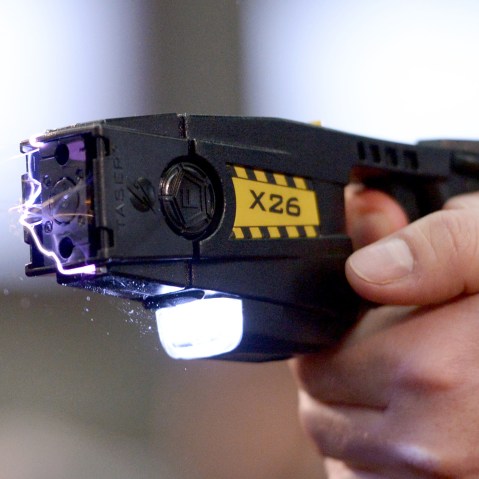 A taser is demonstrated, Nov. 18, 2013. (Photo by Rainer Jensen/AP)
