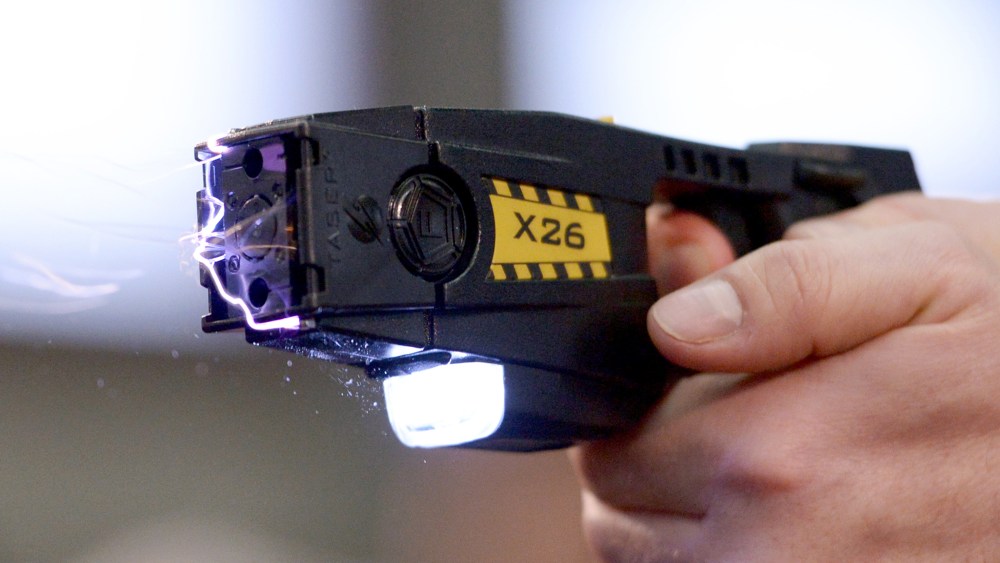 A taser is demonstrated, Nov. 18, 2013. (Photo by Rainer Jensen/AP)
