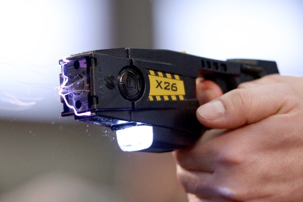 A taser is demonstrated, Nov. 18, 2013. (Photo by Rainer Jensen/AP)