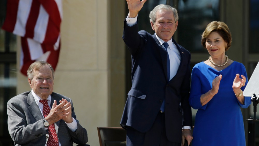 Former president George H.W. Bush, left, applauds with Laura Bush after former president George W. Bush's speech during the dedication of the George W. Bush Presidential Center Thursday, April 25, 2013, in Dallas. (AP Photo/David J. Phillip)