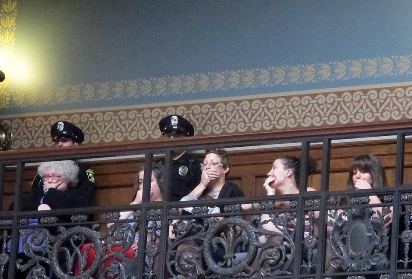 Opponents of a series of Republican-backed bills dealing with abortions hold their hands over their mouths while watching debate in the state Assembly on Thursday, June 13, 2013, in Madison, Wis.  (Photo by Scott Bauer/AP)