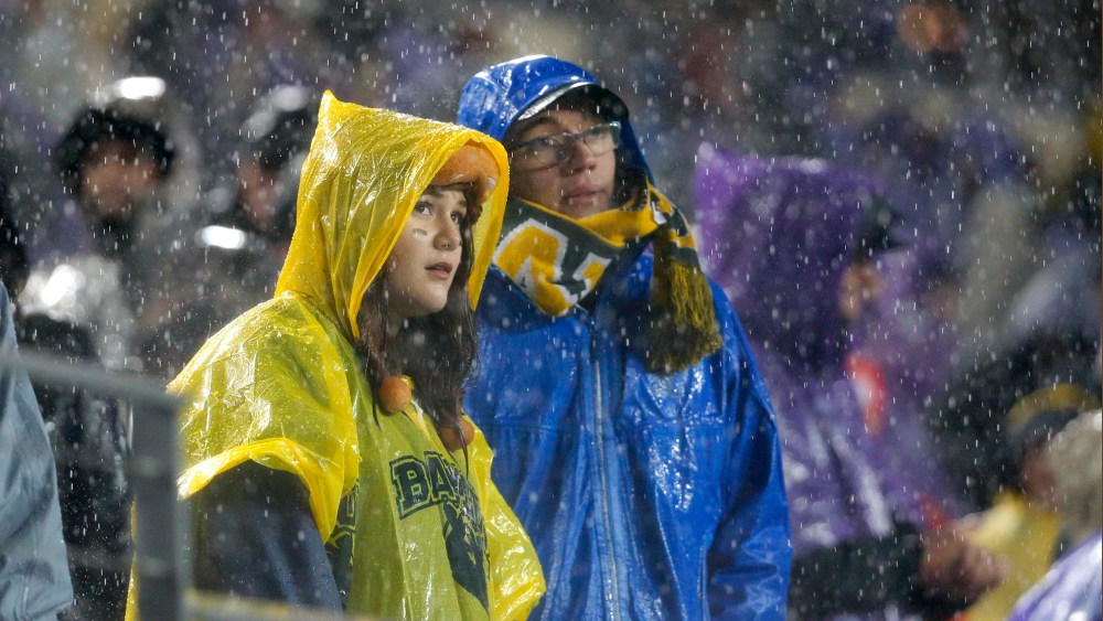 Baylor fans watch the game against TCU in the second half of an NCAA college football game as rain pours down over the stadium, Nov. 27, 2015, Fort Worth, Texas. (Photo by Tony Gutierrez/AP)