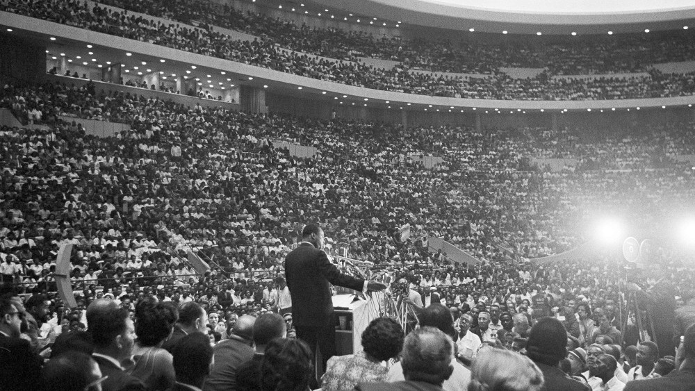 Rev. Martin Luther King Jr., speaks to an overflow crowd in Detroit's Cobo Hall Arena on Sunday, June 24, 1963, following a Freedom March.  (AP Photo)