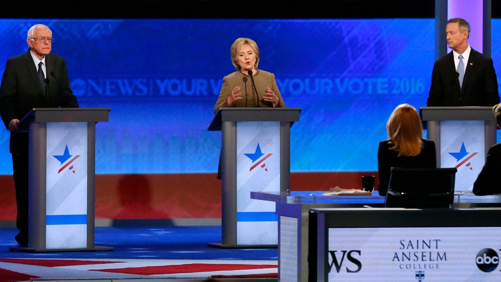 Hillary Clinton, center, speaks between Bernie Sanders and Martin O'Malley during a Democratic presidential primary debate, Dec. 19, 2015, at Saint Anselm College in Manchester, N.H. (Photo by Jim Cole/AP)