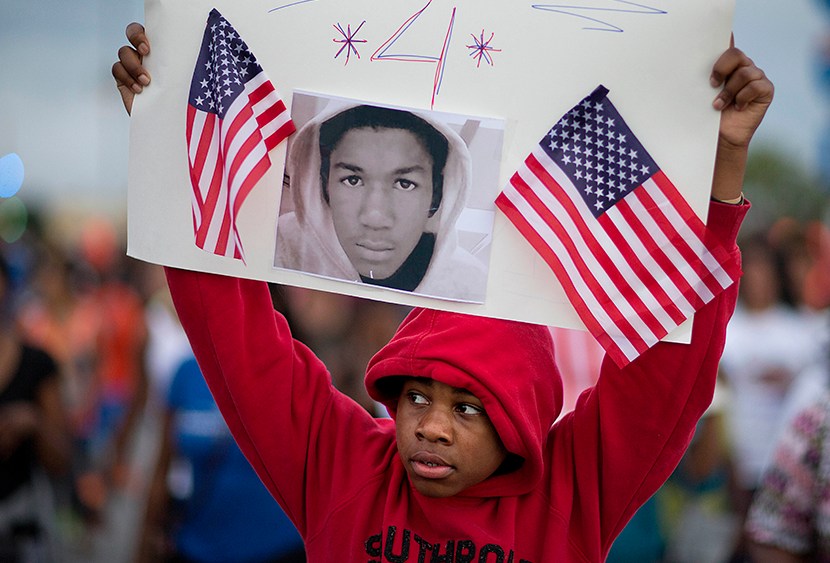 Jaylen Reese, 12, of Atlanta, marches to downtown during a protest of George Zimmerman's not guilty verdict in the 2012 shooting death of teenager Trayvon Martin, Monday, July 15, 2013, in Atlanta. (Photo by David Goldman/AP)